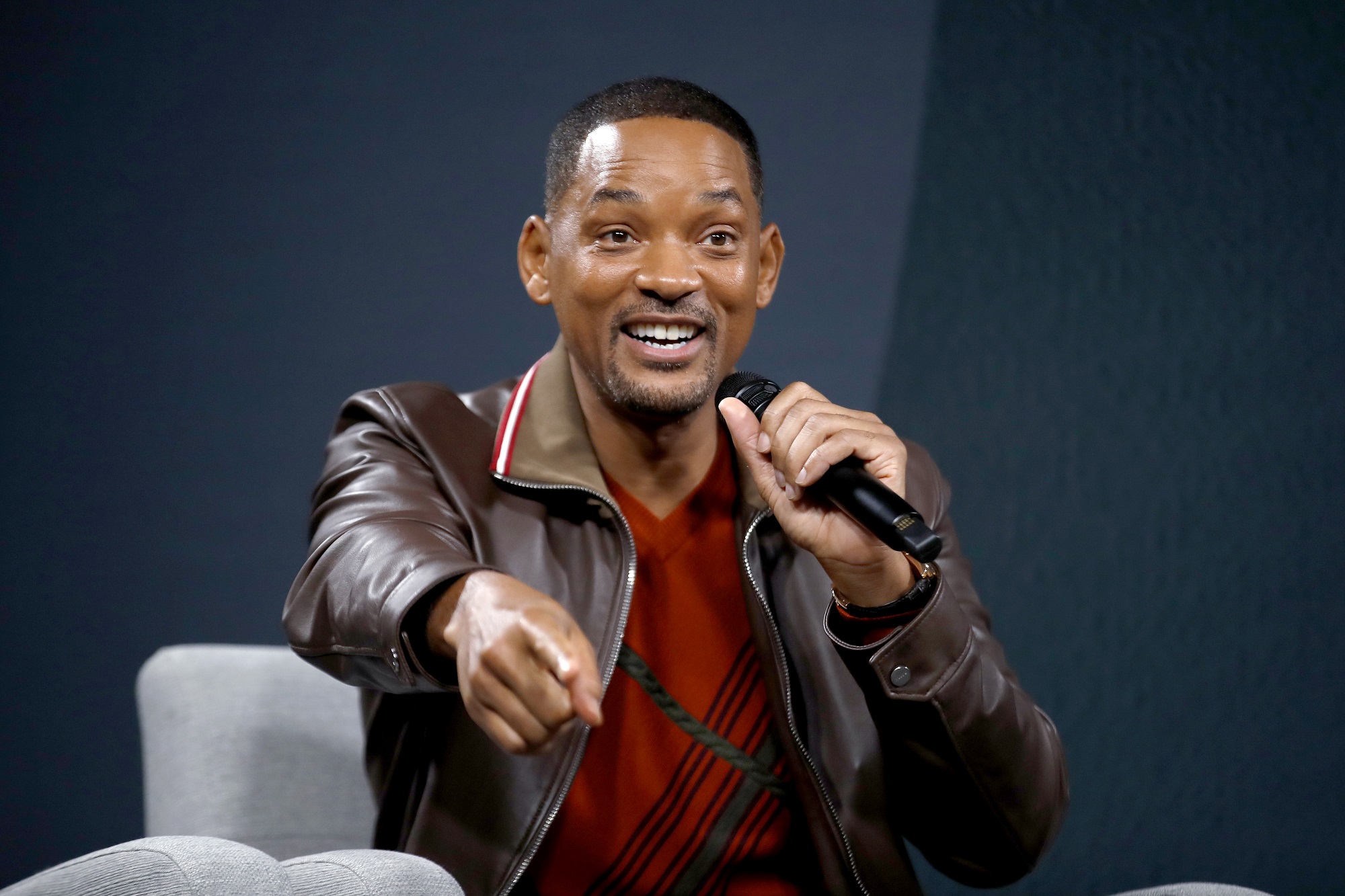 Will Smith sitting in a chair and pointing