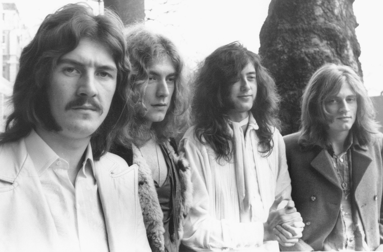 Photo of Led Zeppelin with 2 members looking at camera and 2 members looking away