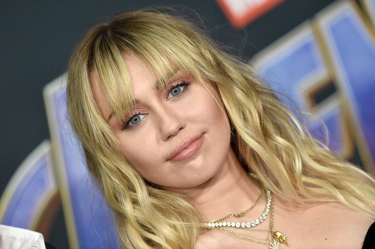 Miley Cyrus wearing a necklace looking at the camera at the 'Avengers: Endgame' premiere