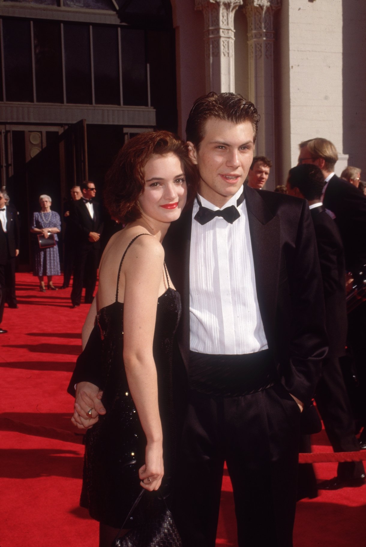 1989: American actors Christian Slater and Winona Ryder pose while holding hands on the red carpet, as they attend the Academy Awards