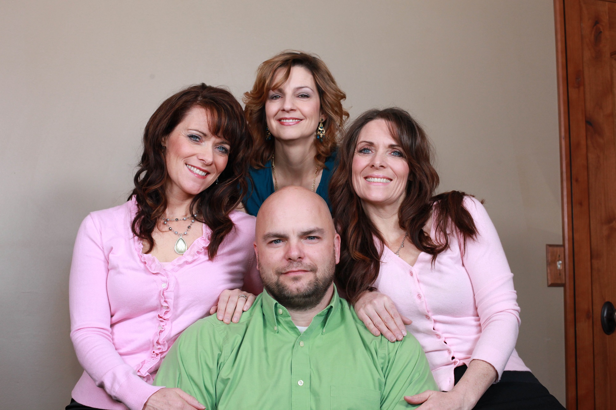 Joe Darger, 42, poses for a picture with his three wives Valerie, 41, Alina, 42 and Vicki, 41 on March 04, 2012