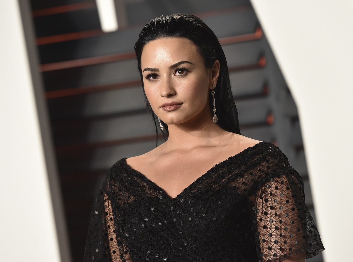 Demi Lovato dressed in black looking at the camera