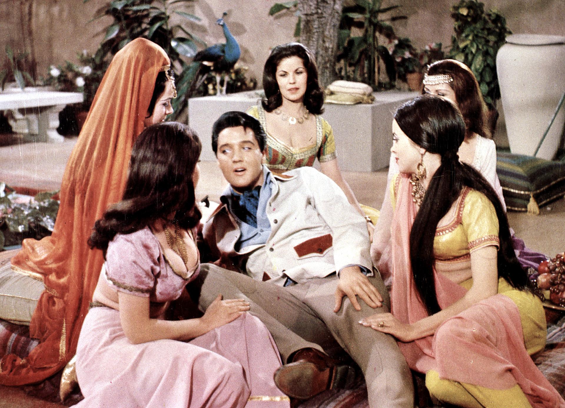 Elvis Presley surrounded by women in Harum Scarum
