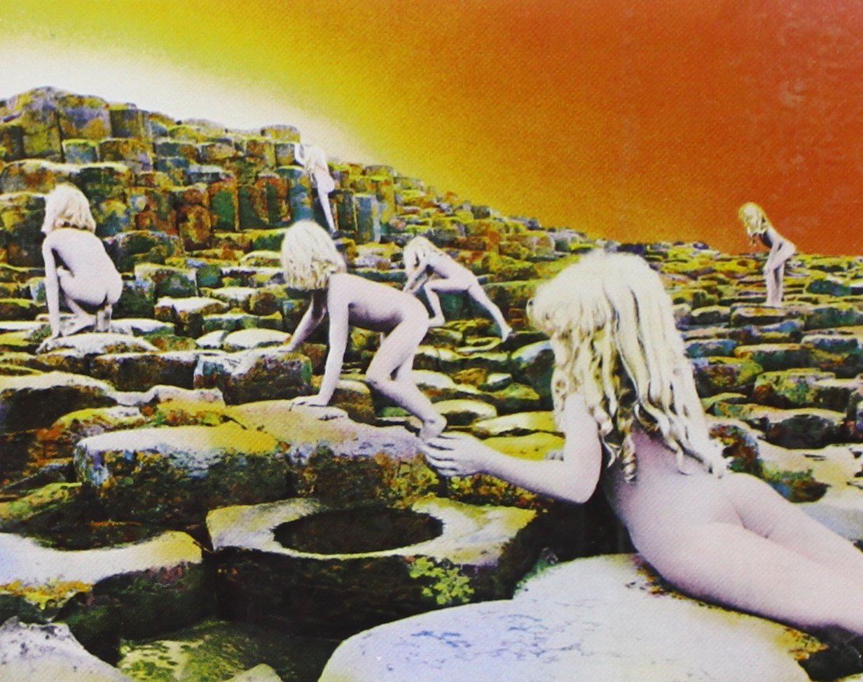 Cover art detail from 'Houses of the Holy' featuring naked young blond children climbing on rocks with an orange background
