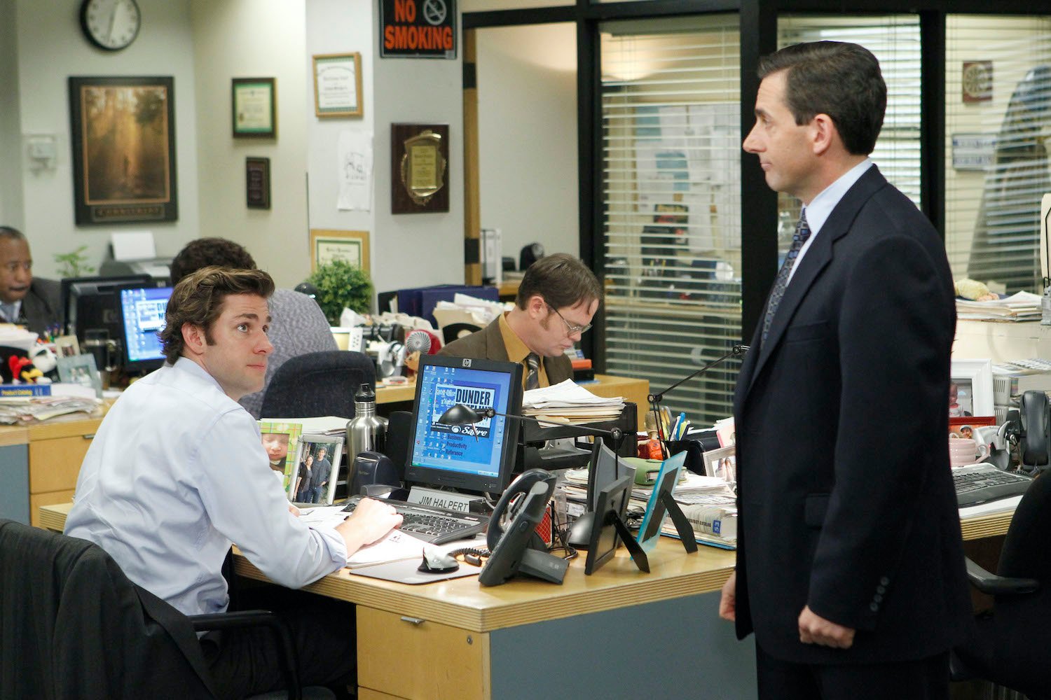 'The Office' cast: John Krasinski as Jim Halpert, Rainn Wilson as Dwight Schrute, and Steve Carell as Michael Scott at Jim's desk