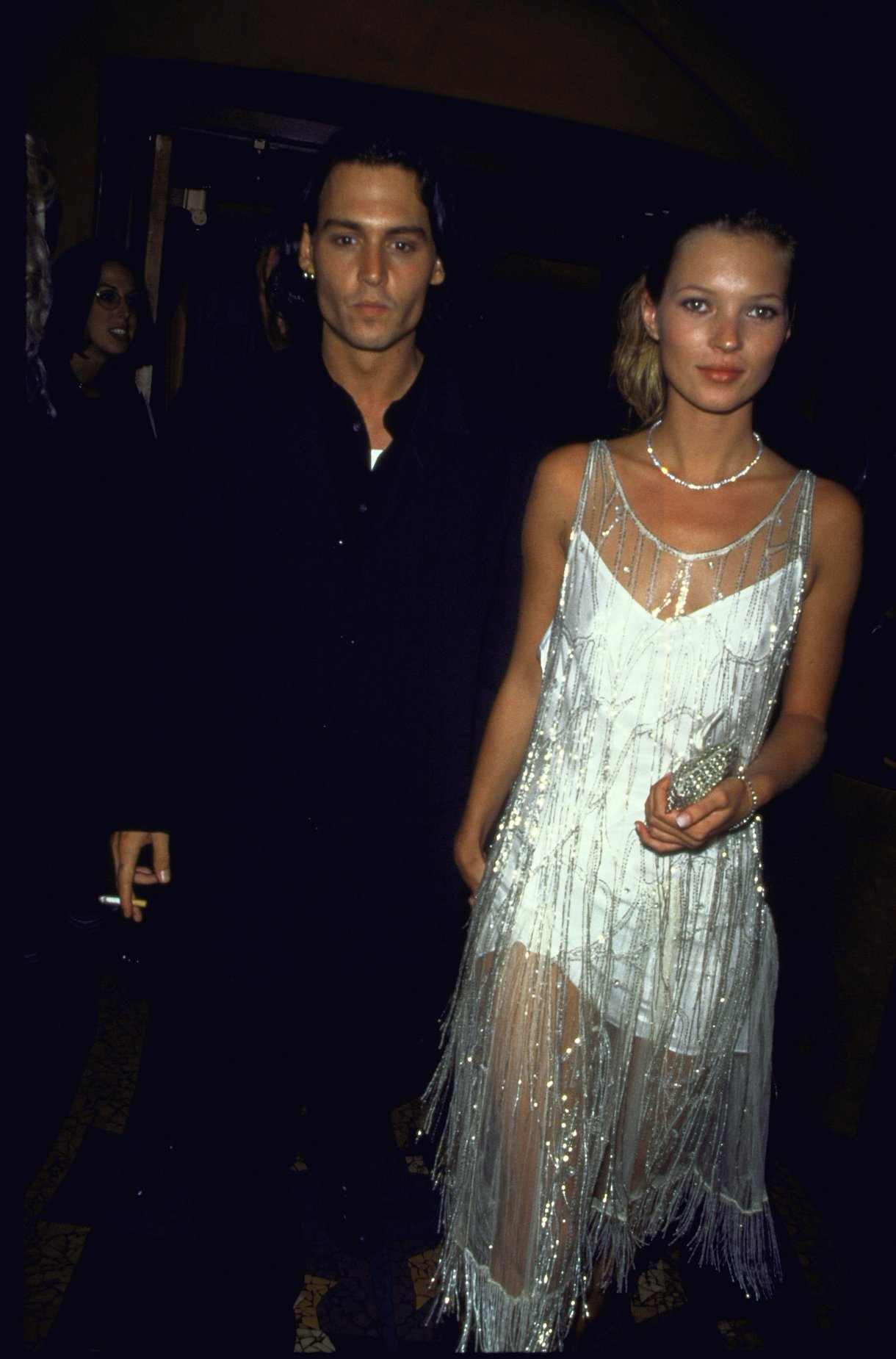 Actor Johnny Depp with girlfriend model Kate Moss wearing silk slip Calvin Klein dress