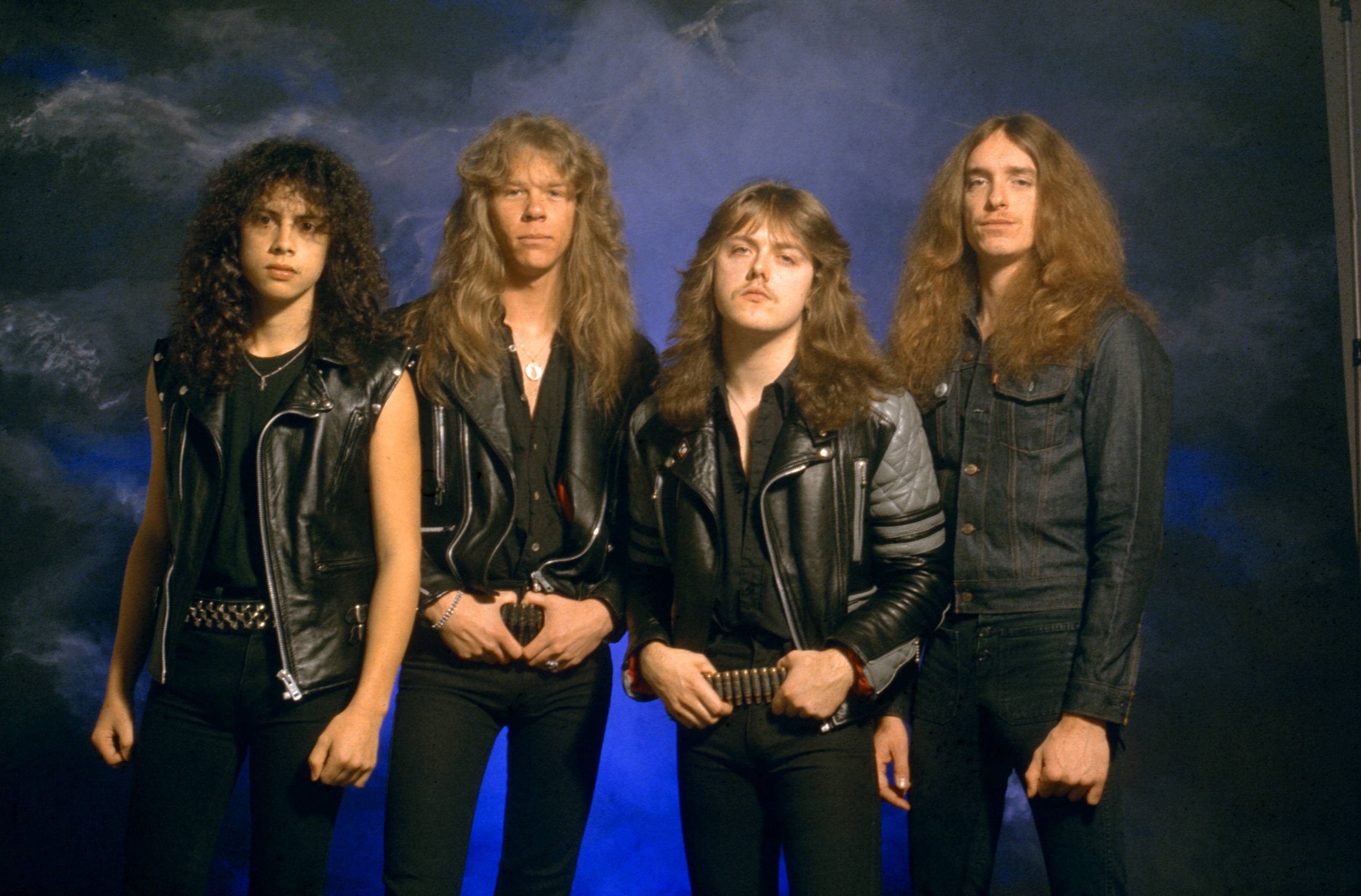 Metallica in black in front of a blue background