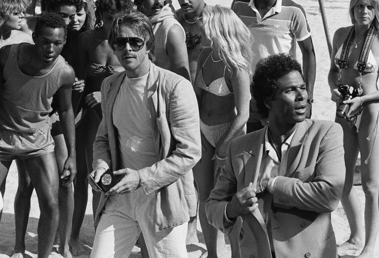 Don Johnson and Philip Michael Thomas work in a crowd of extras on the beach during a 'Miami Vice' shoot