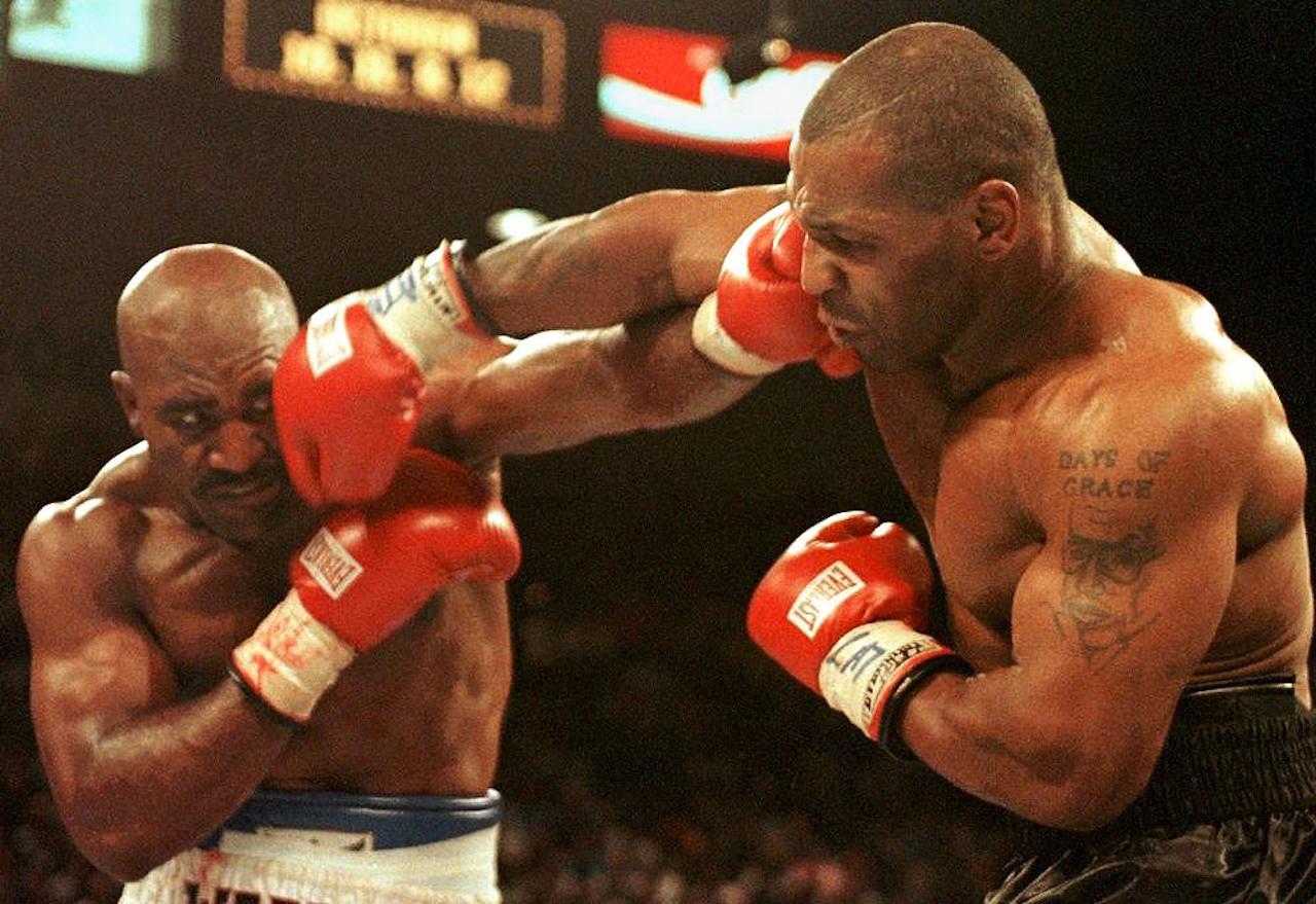 Evander Holyfield (L) and Mike Tyson (R) trade punches 28 June in their WBA heavyweight Cchampionship fight