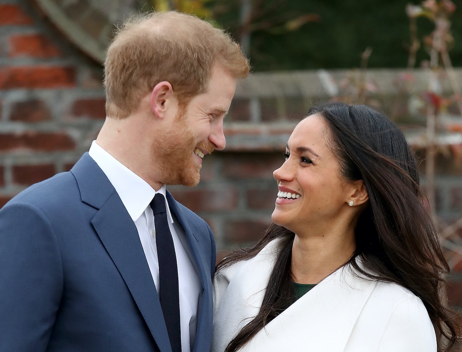 Prince Harry and Meghan Markle during an official photocall to announce their engagement at The Sunken Gardens at Kensington Palace in 2017