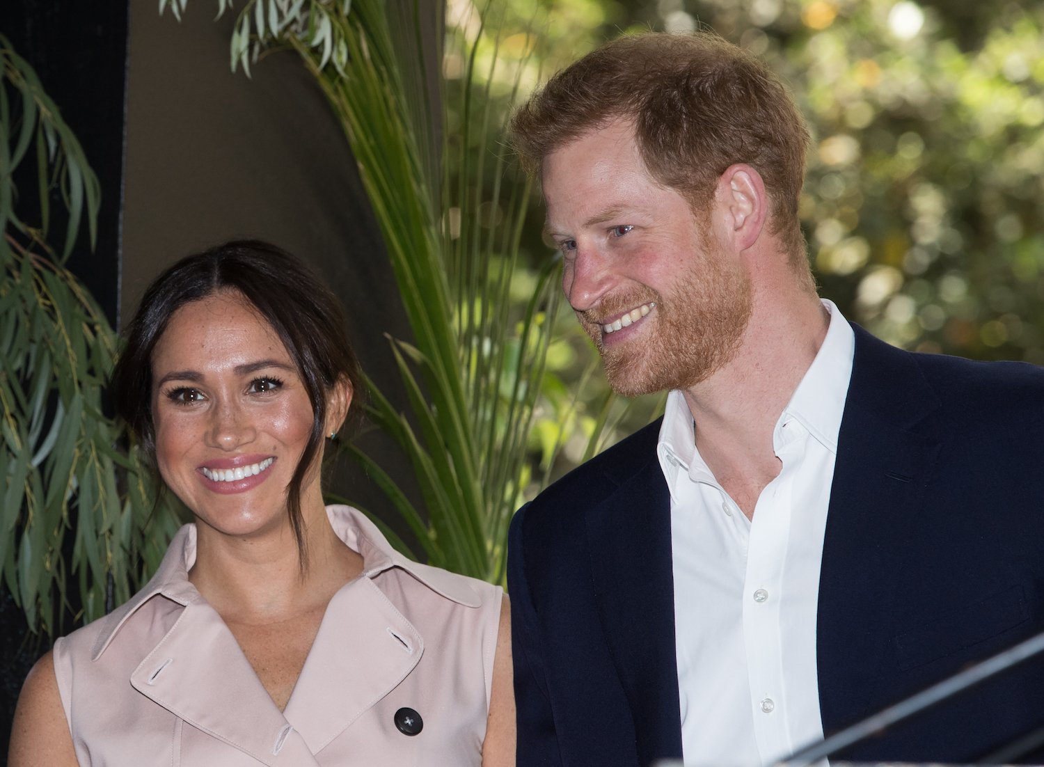 Meghan Markle and Prince Harry smile at a business reception at the British High Commissioner’s Residence in Johannesburg, South Africa
