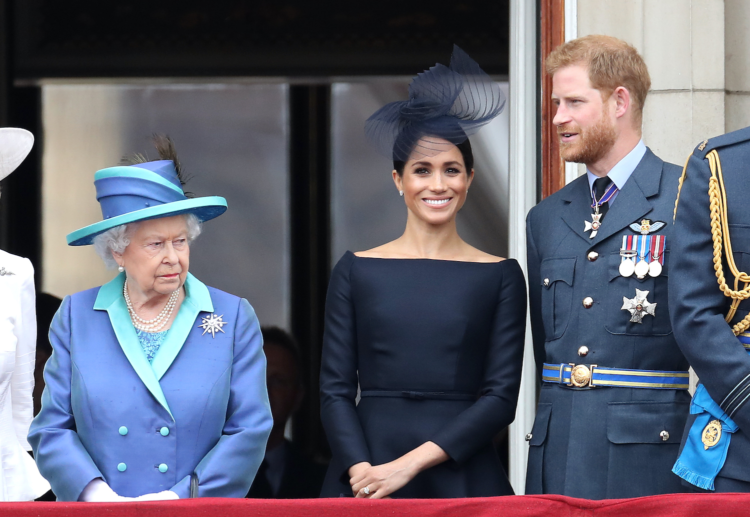 Queen Elizabeth II, Prince Harry, and Meghan Markle on the balcony of Buckingham Palace for the Centenary of the RAF on July 10, 2018