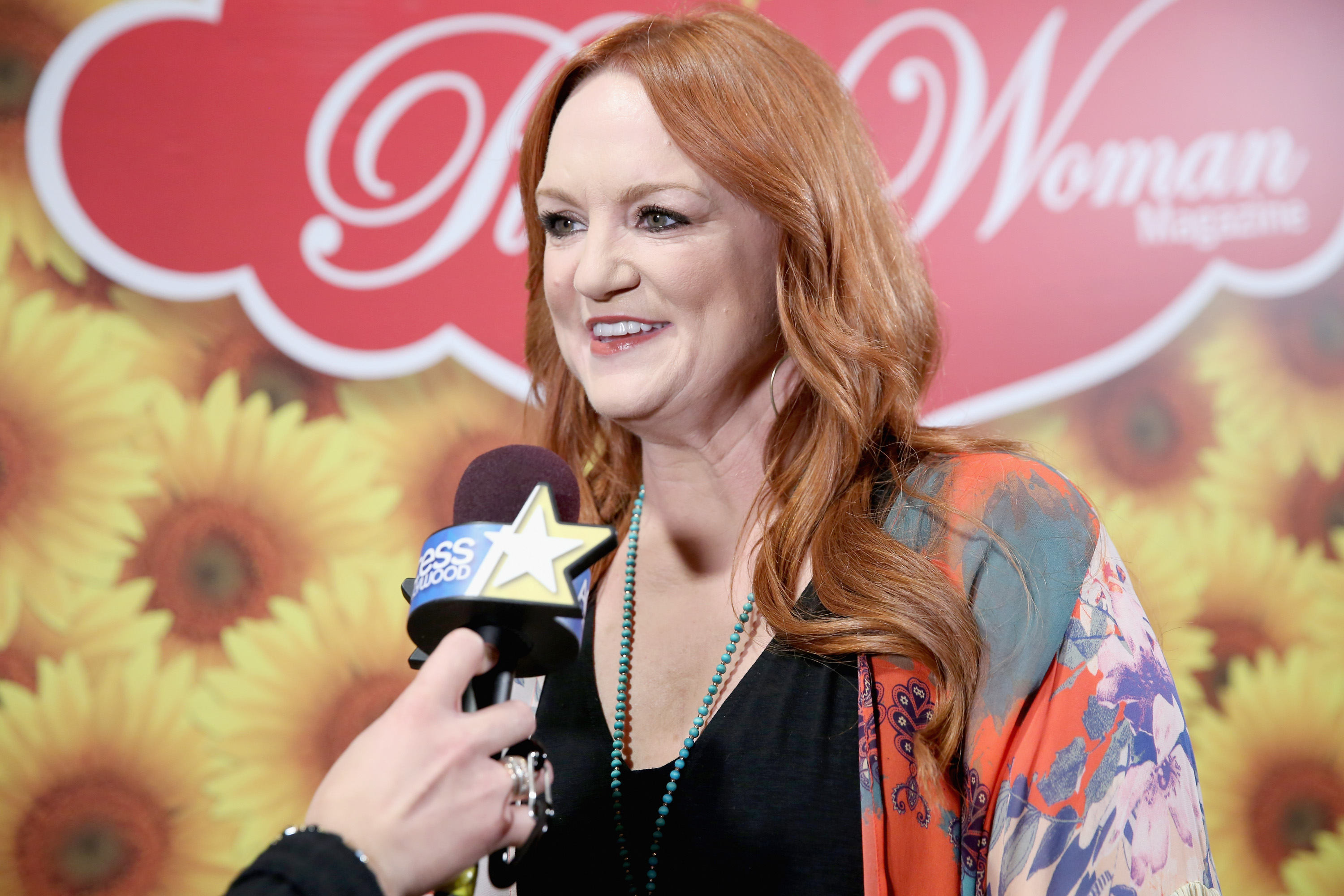 Ree Drummond speaks into a microphone as she's interviewed during an event for The Pioneer Woman Magazine