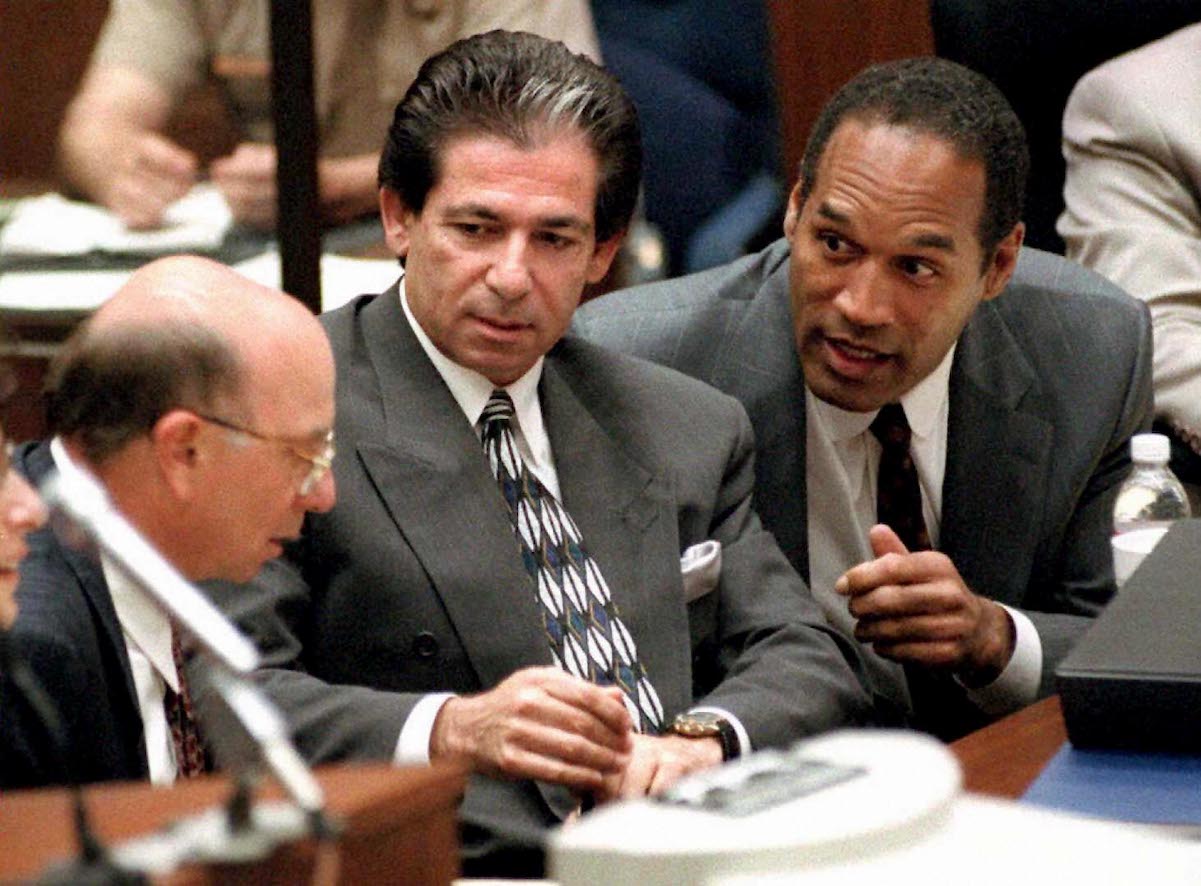 Robert Kardashian Sr., center, sits next to O.J. simpson, right, during Simpson's murder trial in 1995.