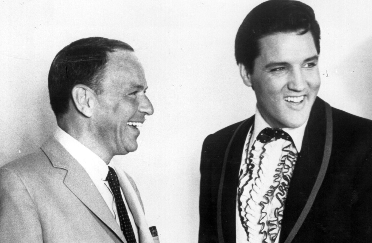 1965: Frank Sinatra and Elvis Presley share a joke together in Hollywood.