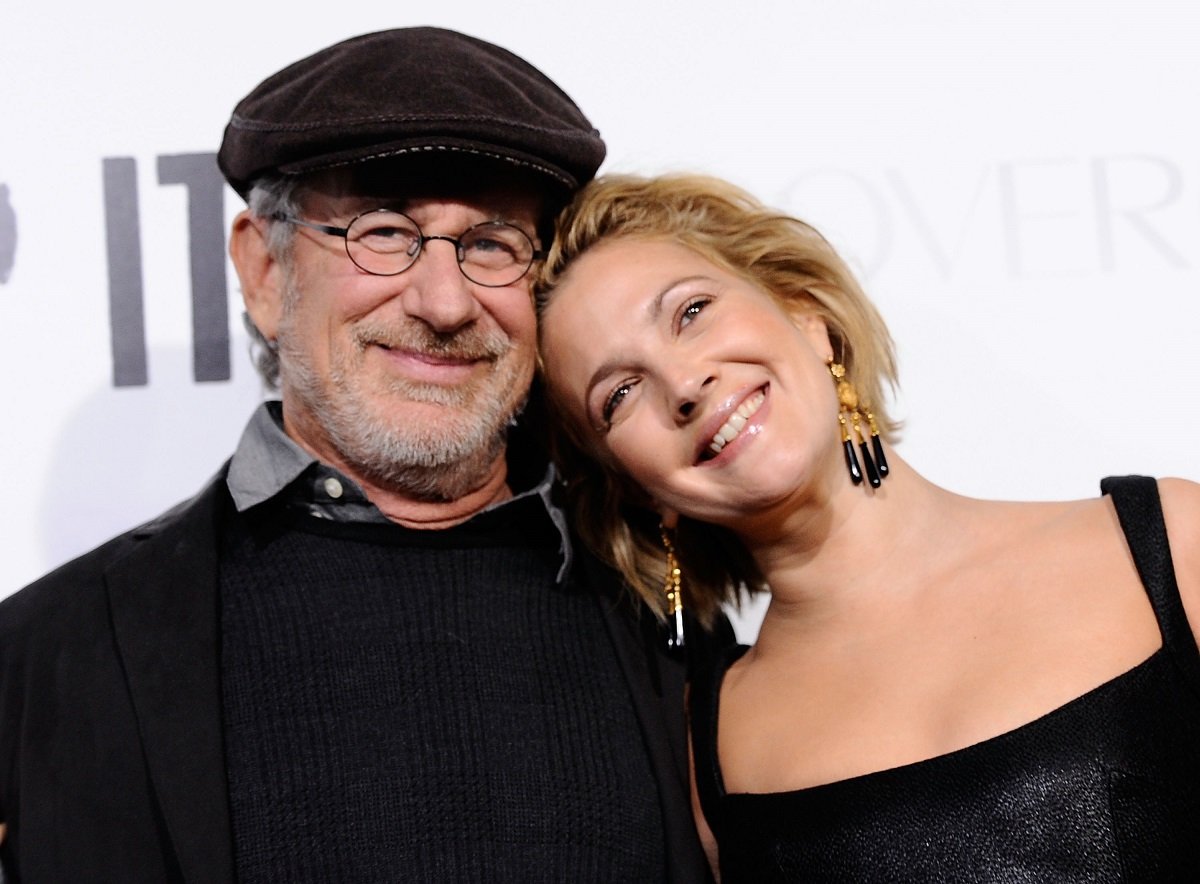 Drew Barrymore (R) leaning her head against Steven Spielberg