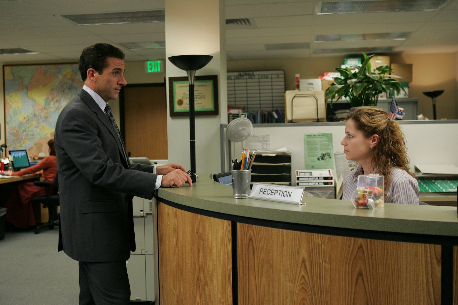 'The Office': Steve Carell stands at the reception desk as Michael Scott with Jenna Fischer as Pam Beesly 