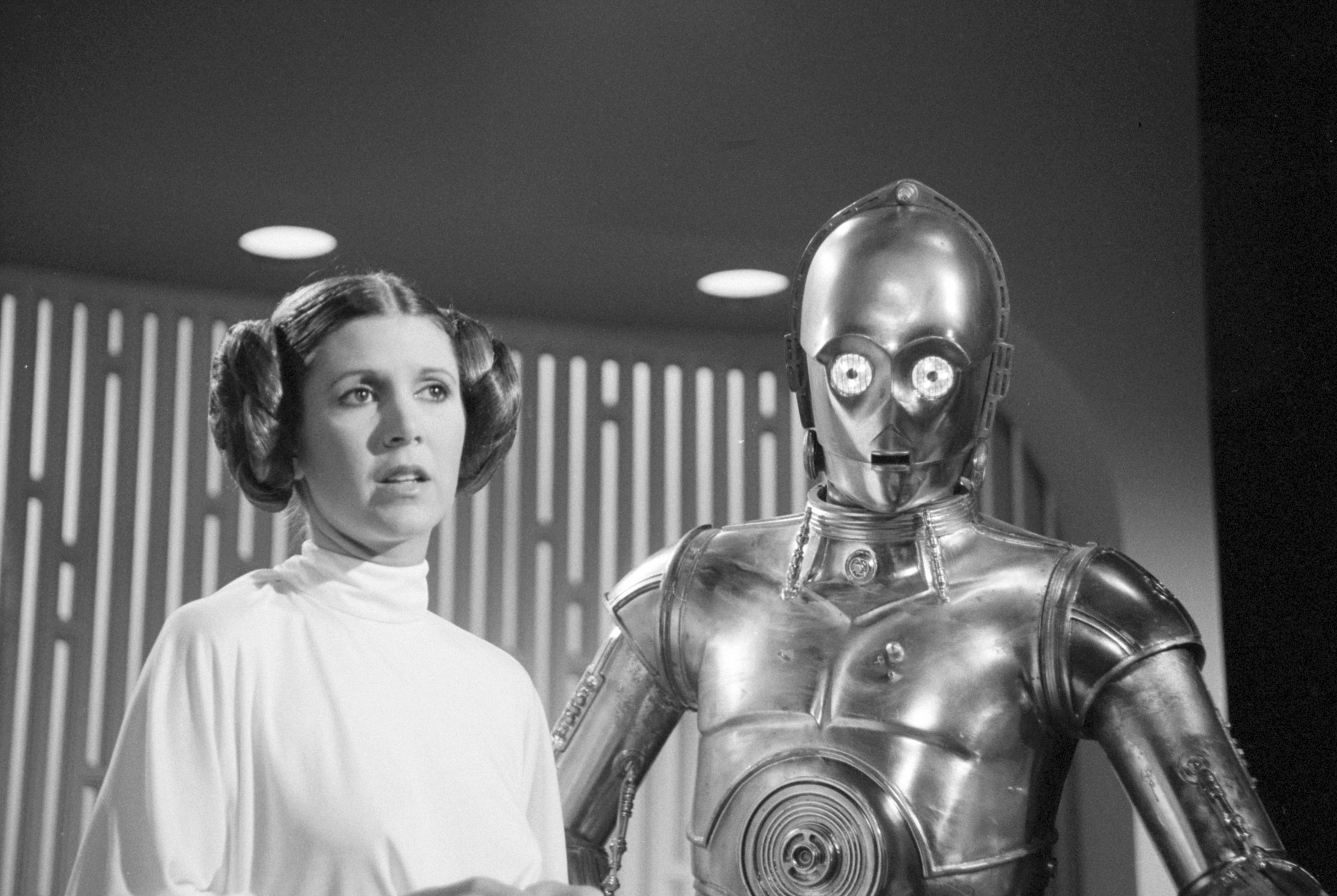 Carrie Fisher and C-3PO near lights