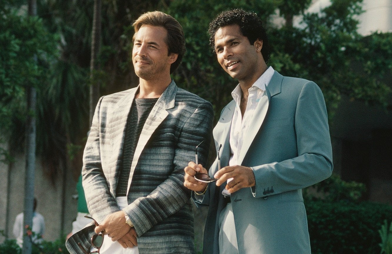 Don Johnson and Philip Michael Thomas smile during a 'Miami Vice' scene 
