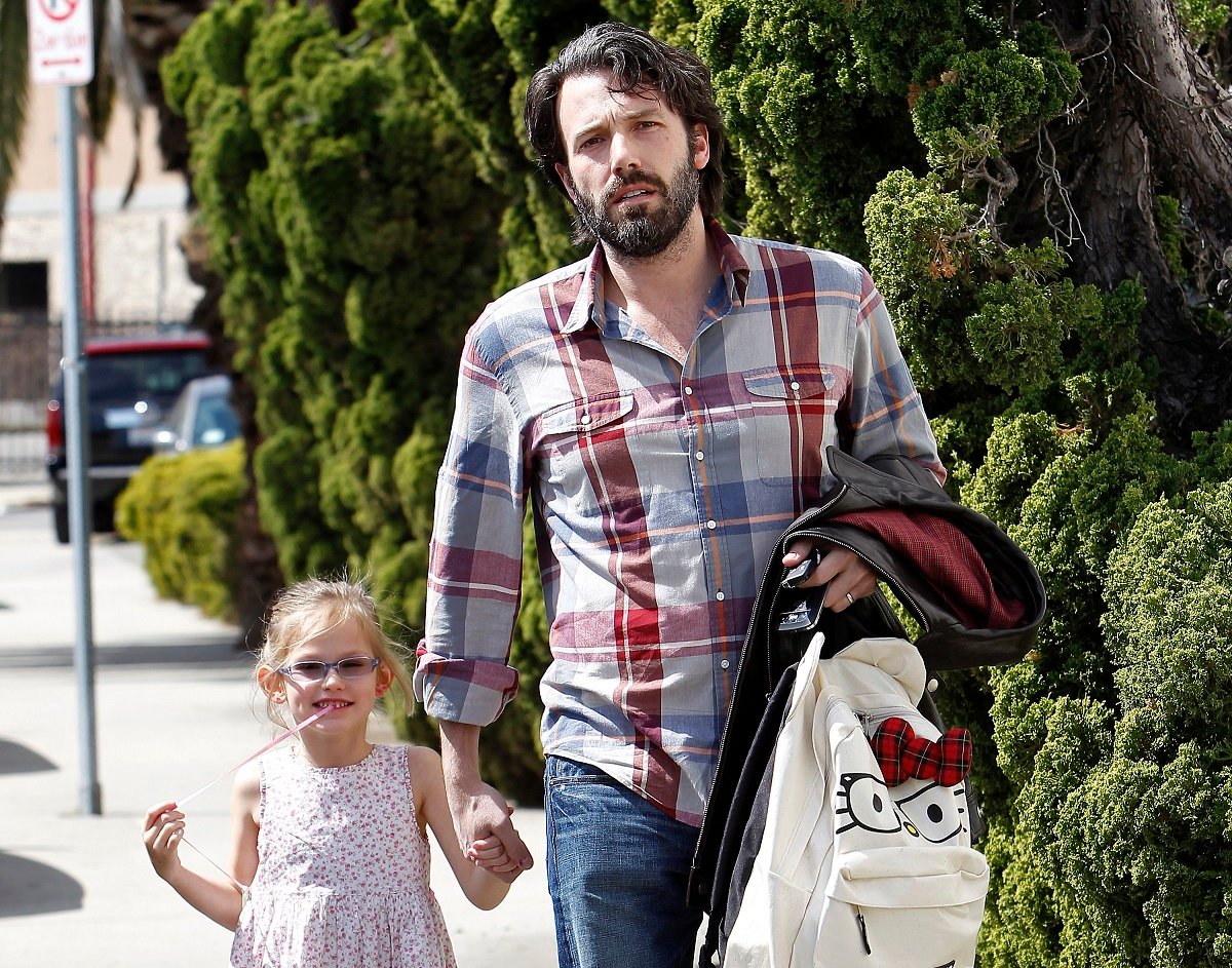 Ben Affleck holding his daughter's hand and walking her down the street