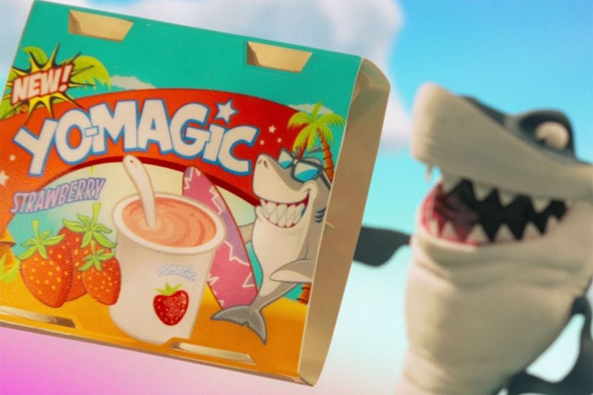 A cartoon shark smiles while holding a package of yogurt called 'Yo-Magic' in Marvel's 'WandaVision' on Disney+ | Disney