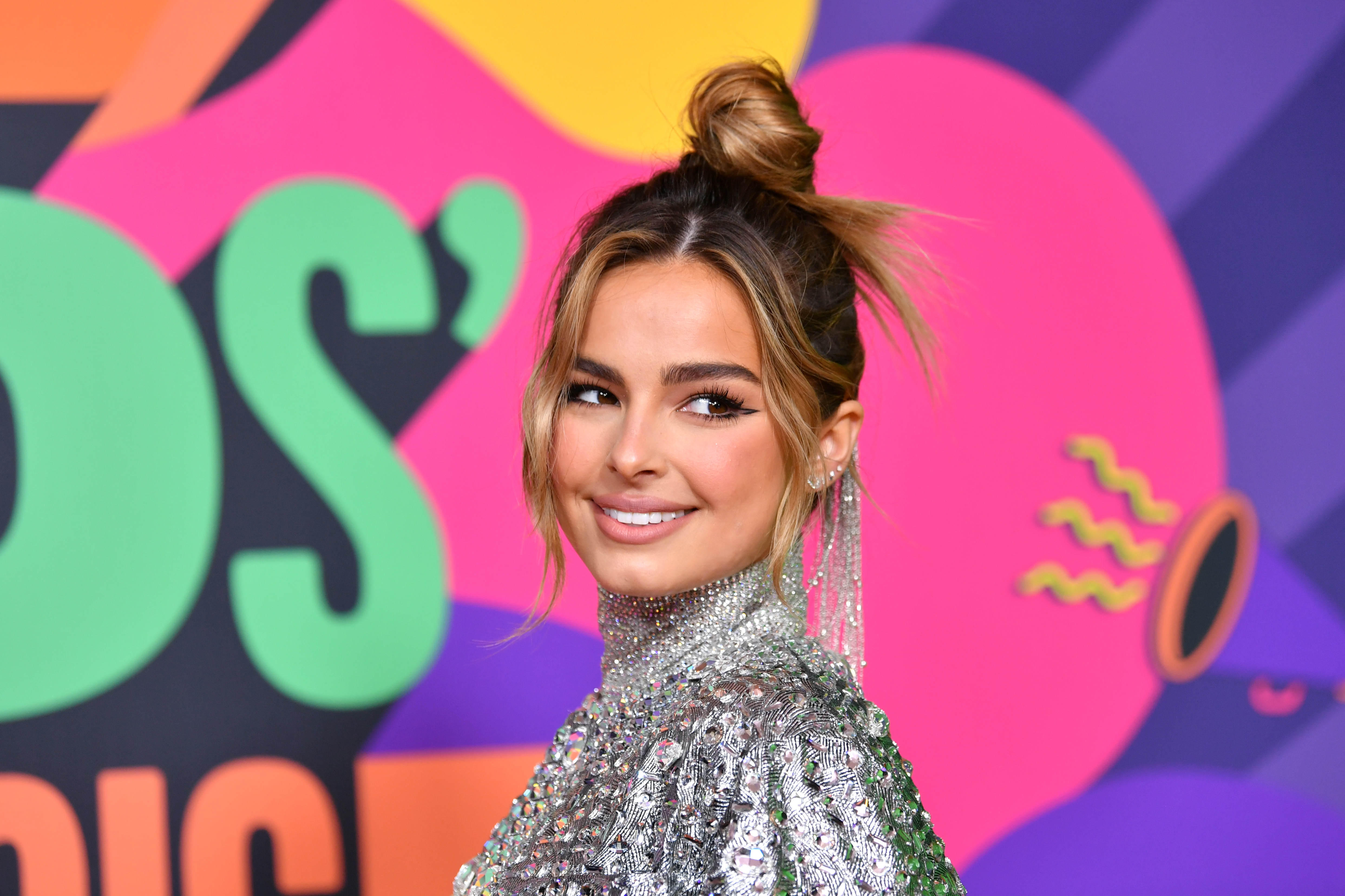 Close up of Addison Rae smiling with her hair in a high bun