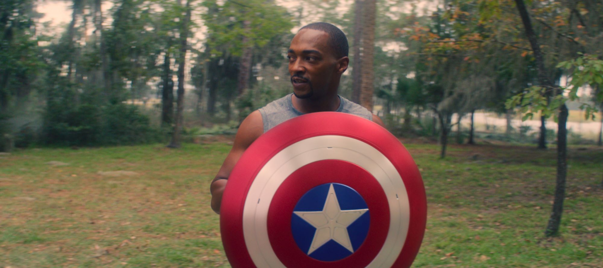 Anthony Mackie holding the Captain America shield in 'The Falcon and the Winter Soldier' at the end of season 1