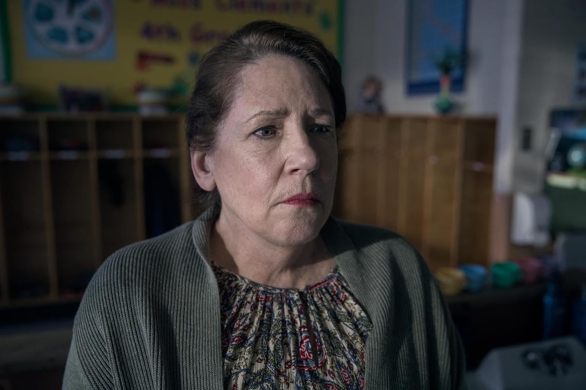 Aunt Lydia (Ann Dowd) looks sad and pensive standing in a classroom in 'The Handmaid's Tale' Season 3 Episode 8, 'Unfit'