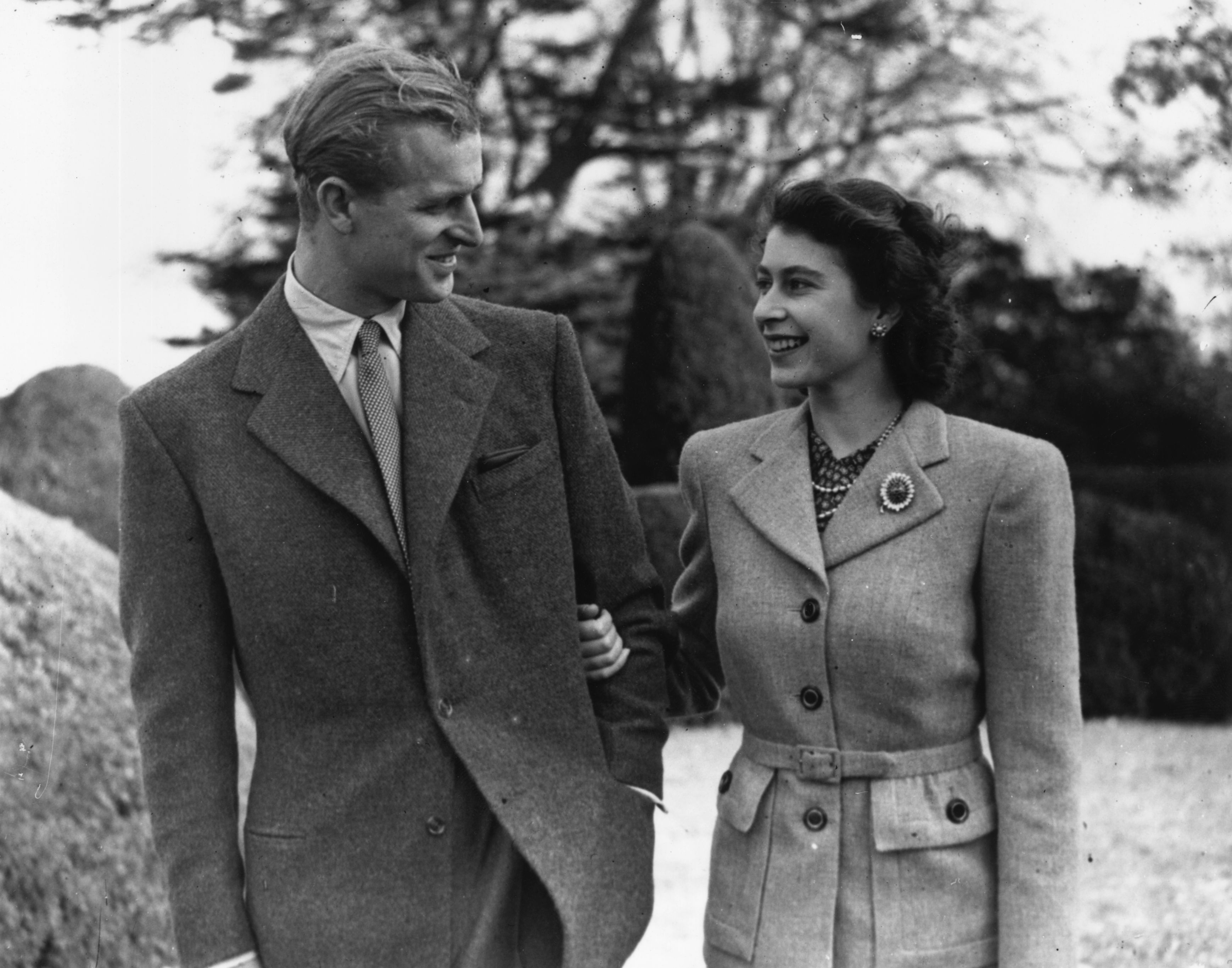 Black-and-white photo of then-Princess Elizabeth and Prince Philip enjoying a walk together during their honeymoon