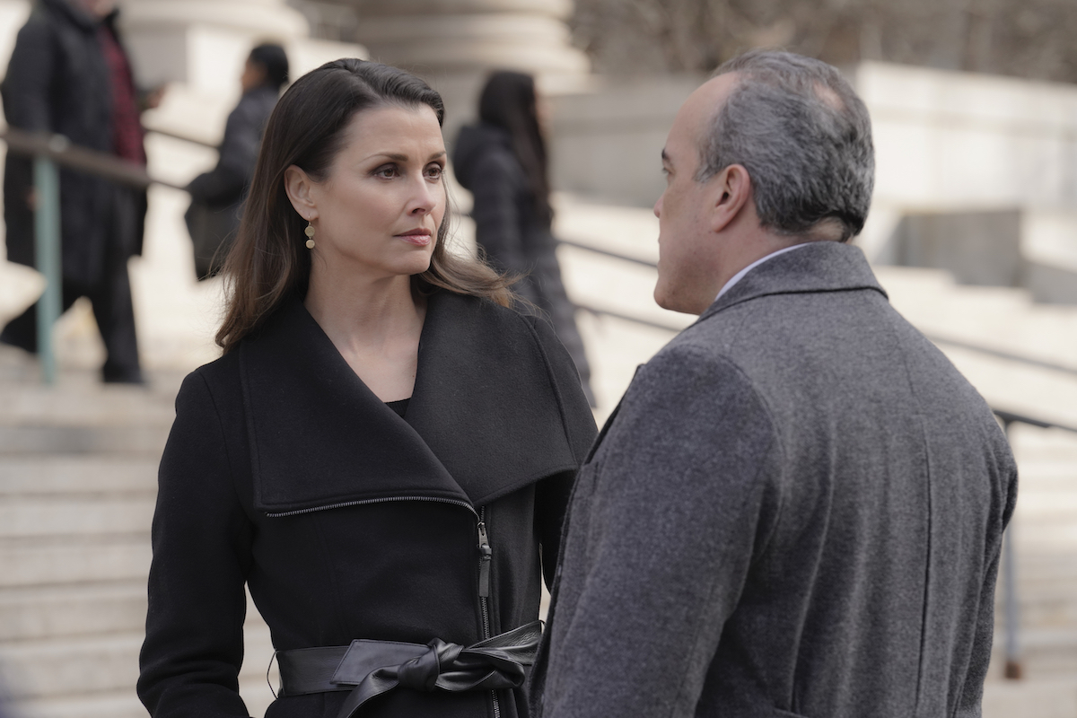 Bridget Moynahan as Erin Reagan and David Zayas as Governor Mendez are talking outside a court building on 'Blue Bloods'