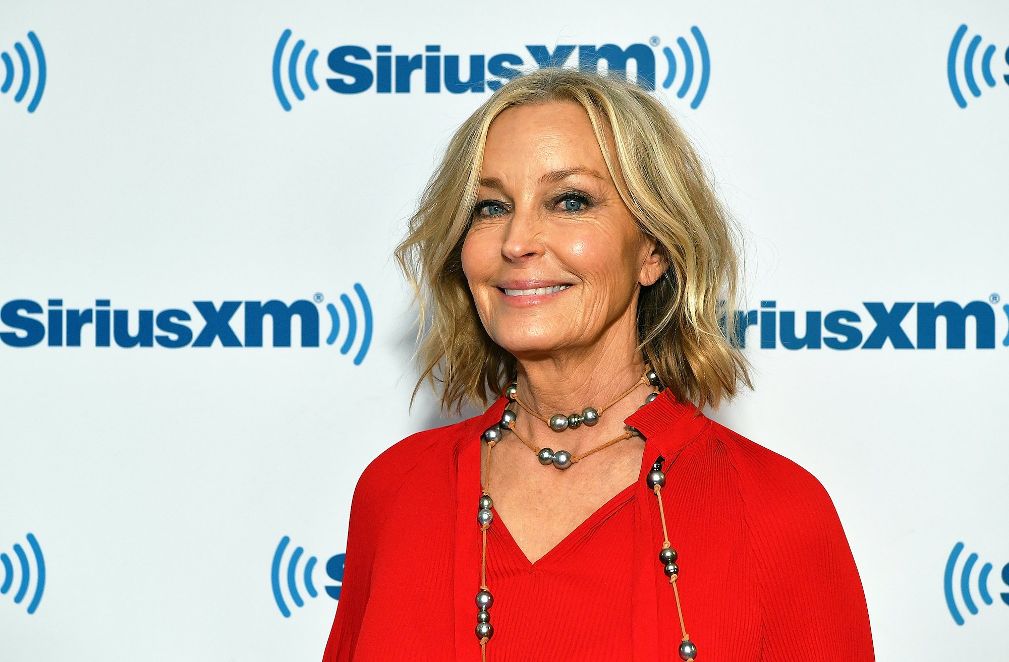 Bo Derek smiling in front of a white background