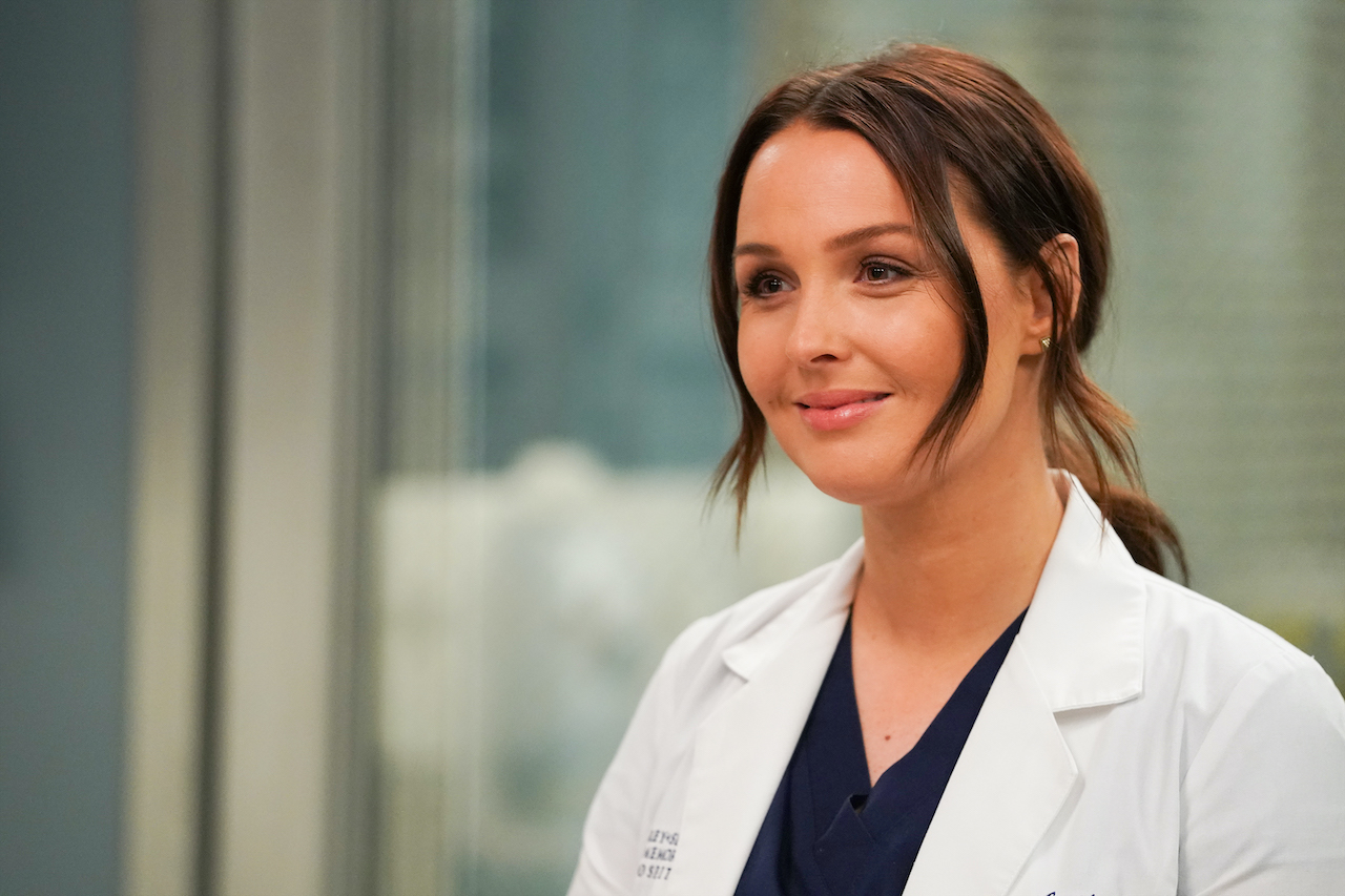 Camilla Luddington smiling and wearing scrubs in a scene from 'Grey's Anatomy' 
