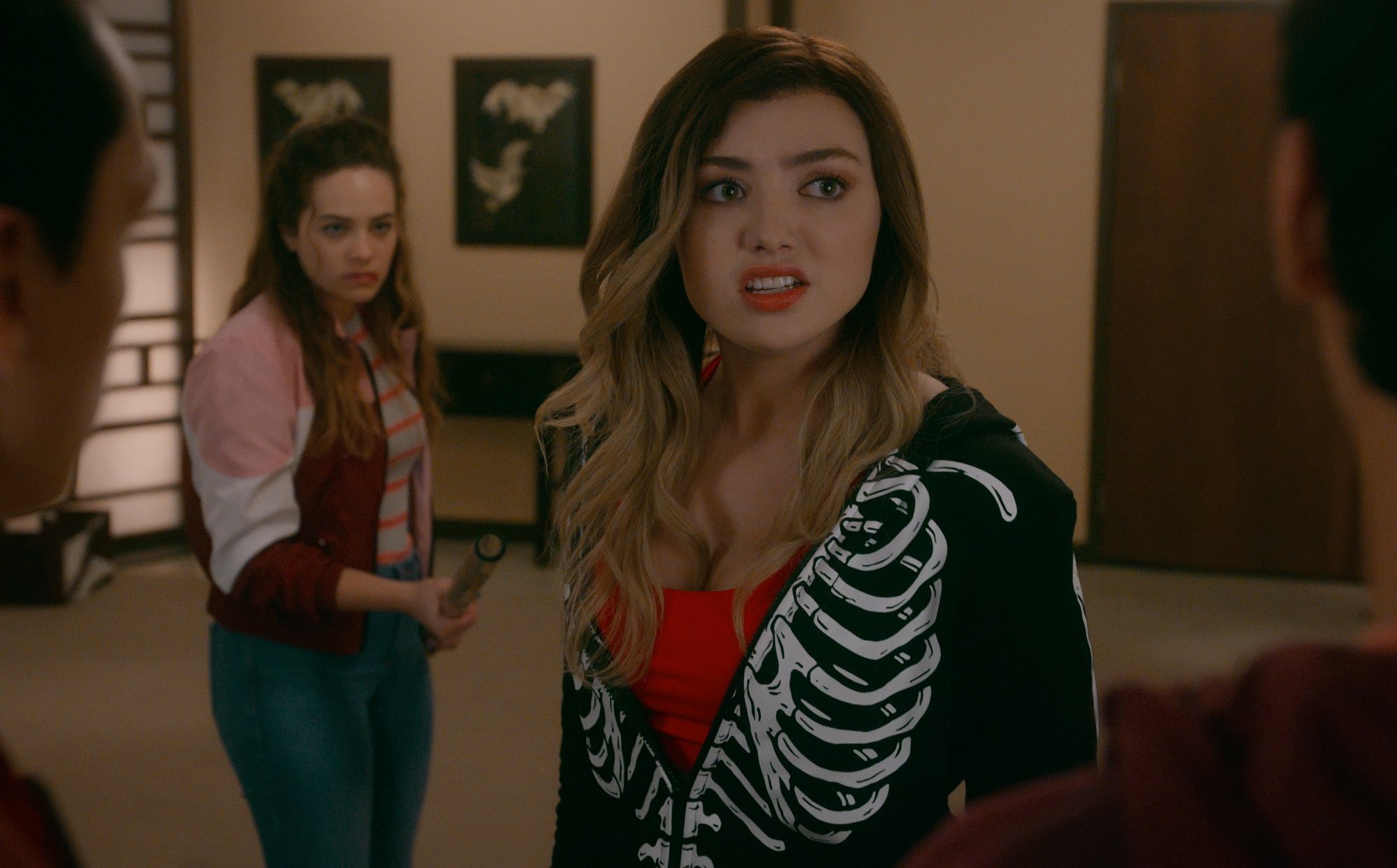 Cobra Kai star Peyton List wears a skeleton sweatshirt unzipped