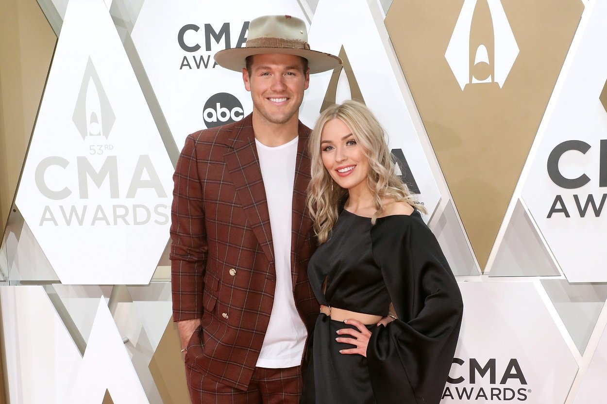 Colton Underwood and Cassie Randolph pose together on the red carpet at the CMA Awards