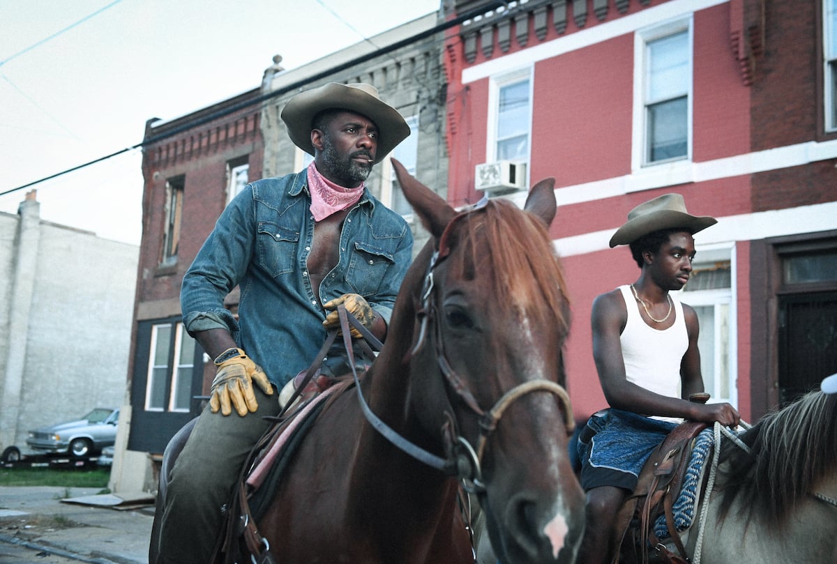 Idris Elba as Harp and Caleb McLaughlin as Cole riding horses in 'Concrete Cowboy'