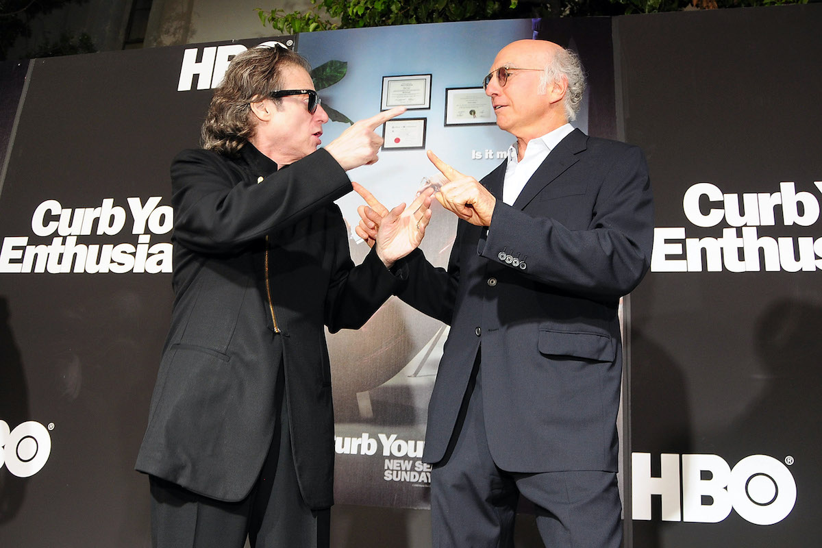 Richard Lewis and Larry David arrive at a red carpet event in 2009