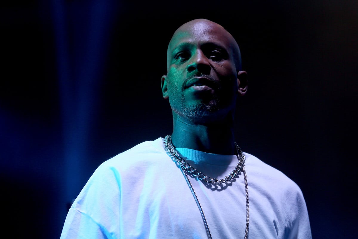 DMX performs on stage cast in blue and green light