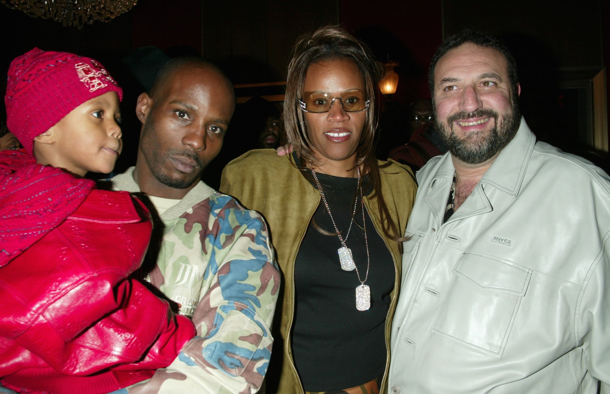 DMX's wife, Tashera Simmons, and his son standing with him at an event