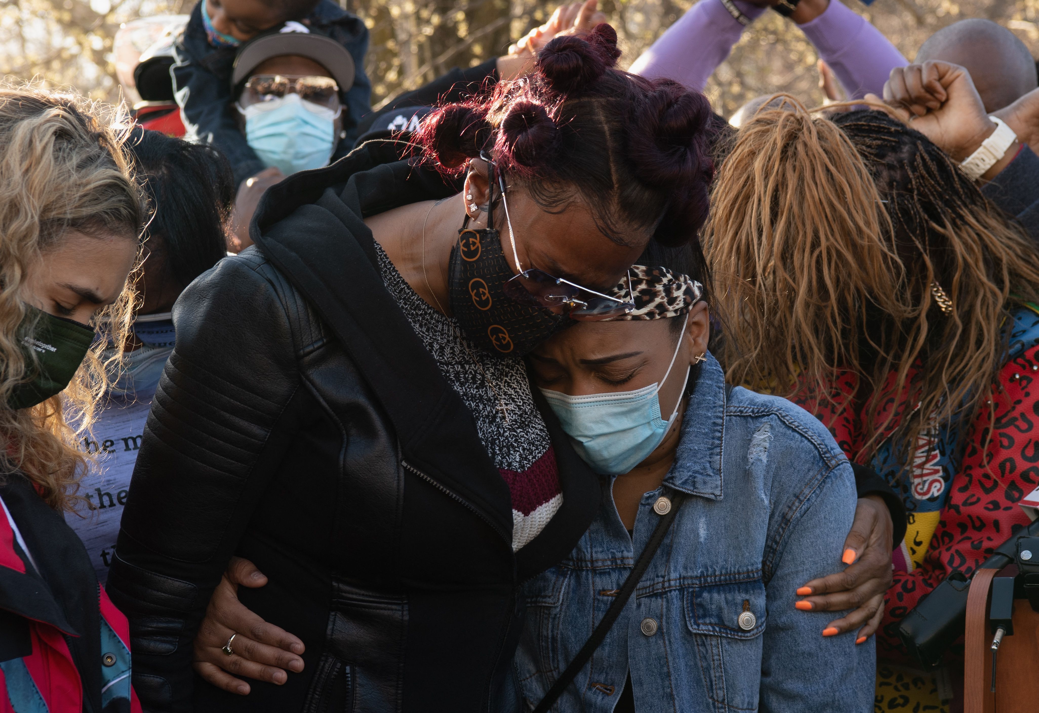 Tashera Simmons and Desiree Lindstrom embrace each other at a memorial for DMX in April 2021.