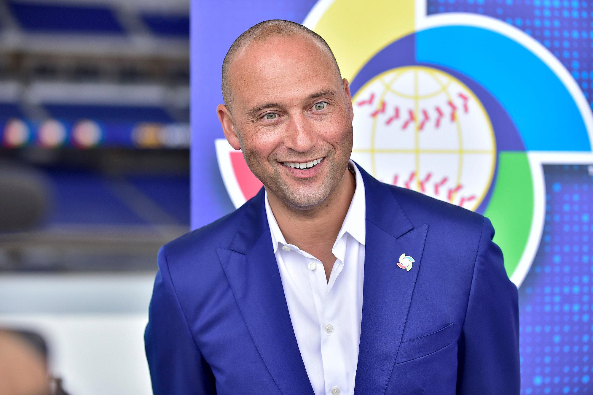 Derek Jeter smiling in front of a blue background