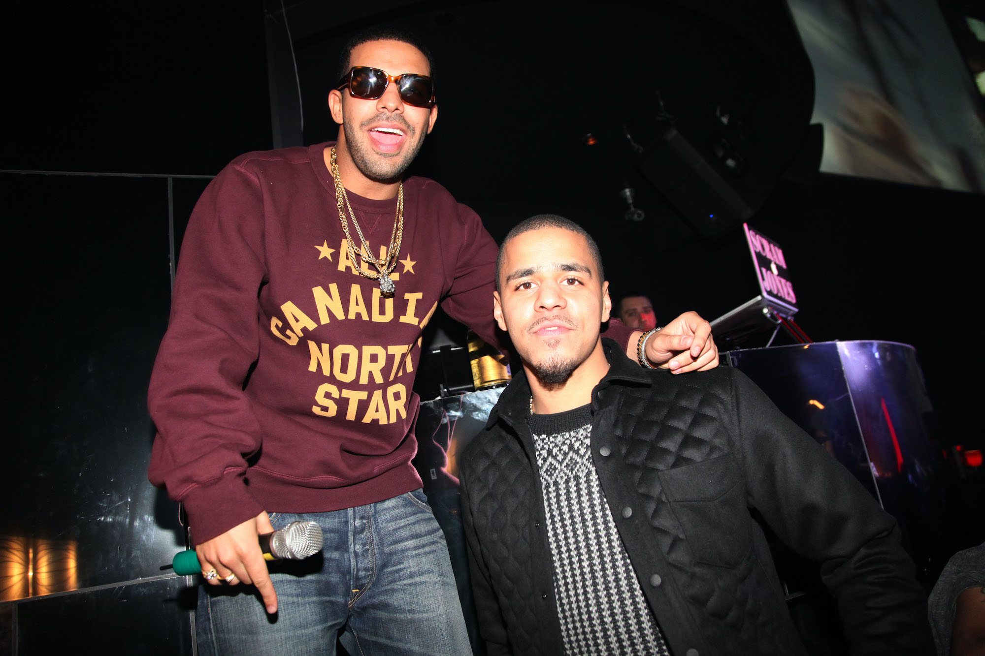 (L-R) Drake and J. Cole in front of a dark background