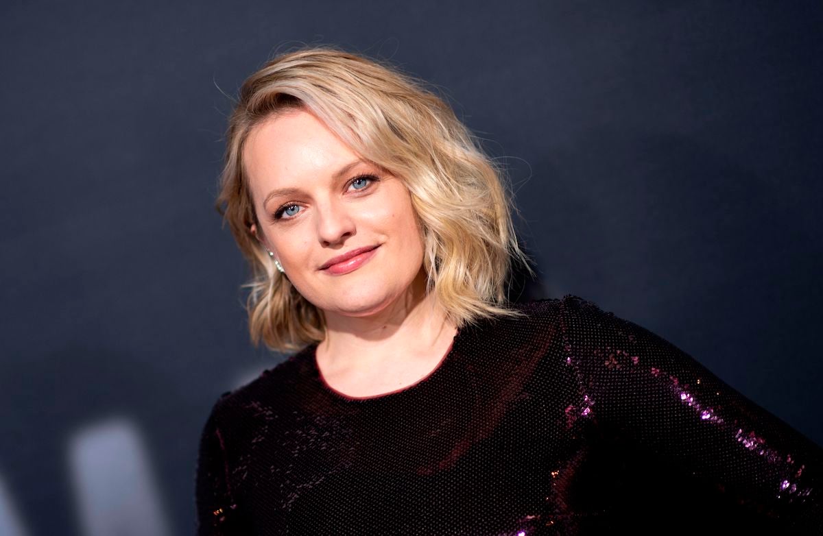 Elisabeth Moss with short blonde hair in a glittering purple dress at the premiere of 'The Invisible Man' in February 2020