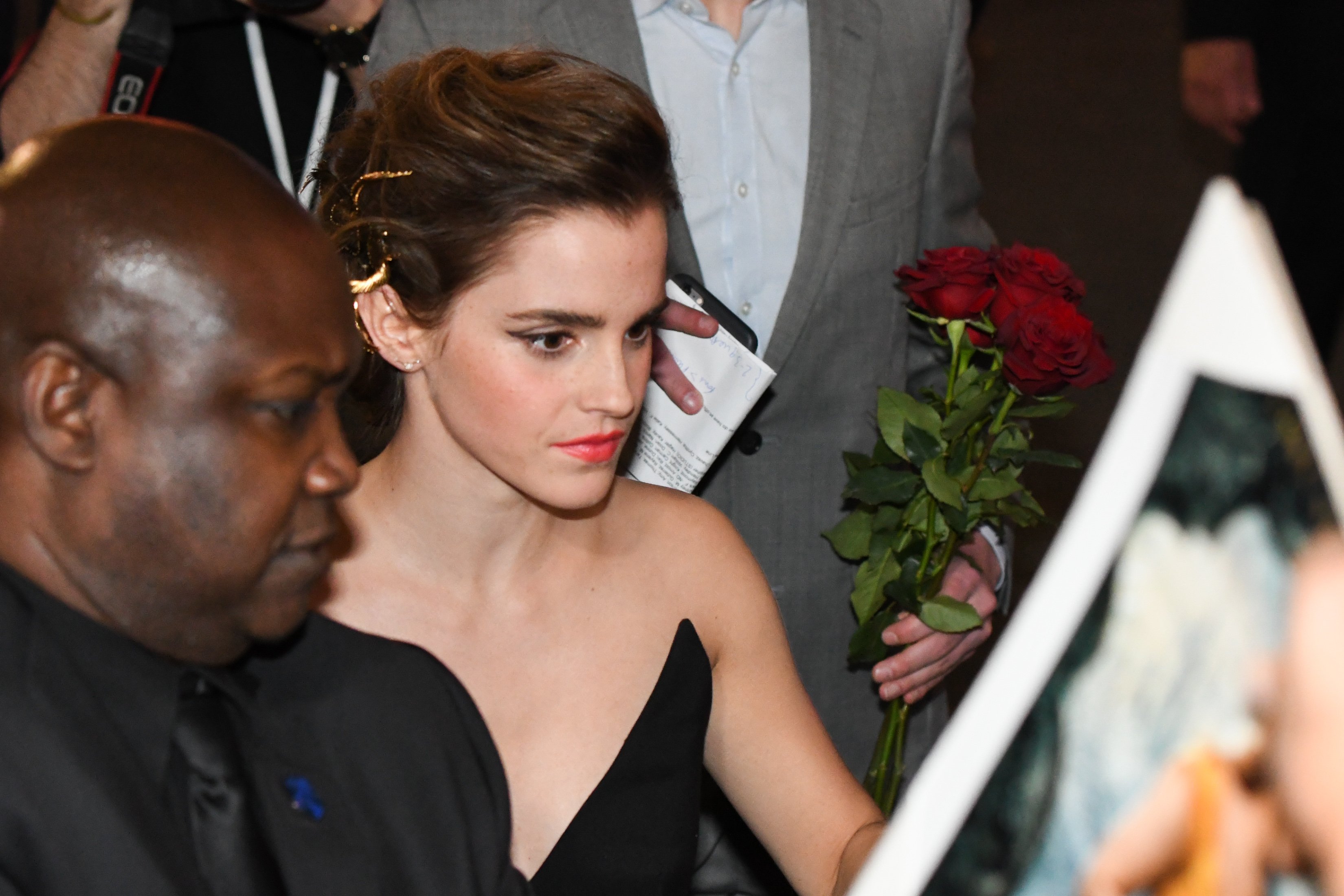 Emma Watson signs autographs for fans at the 2017 premiere of Beauty and the Beast