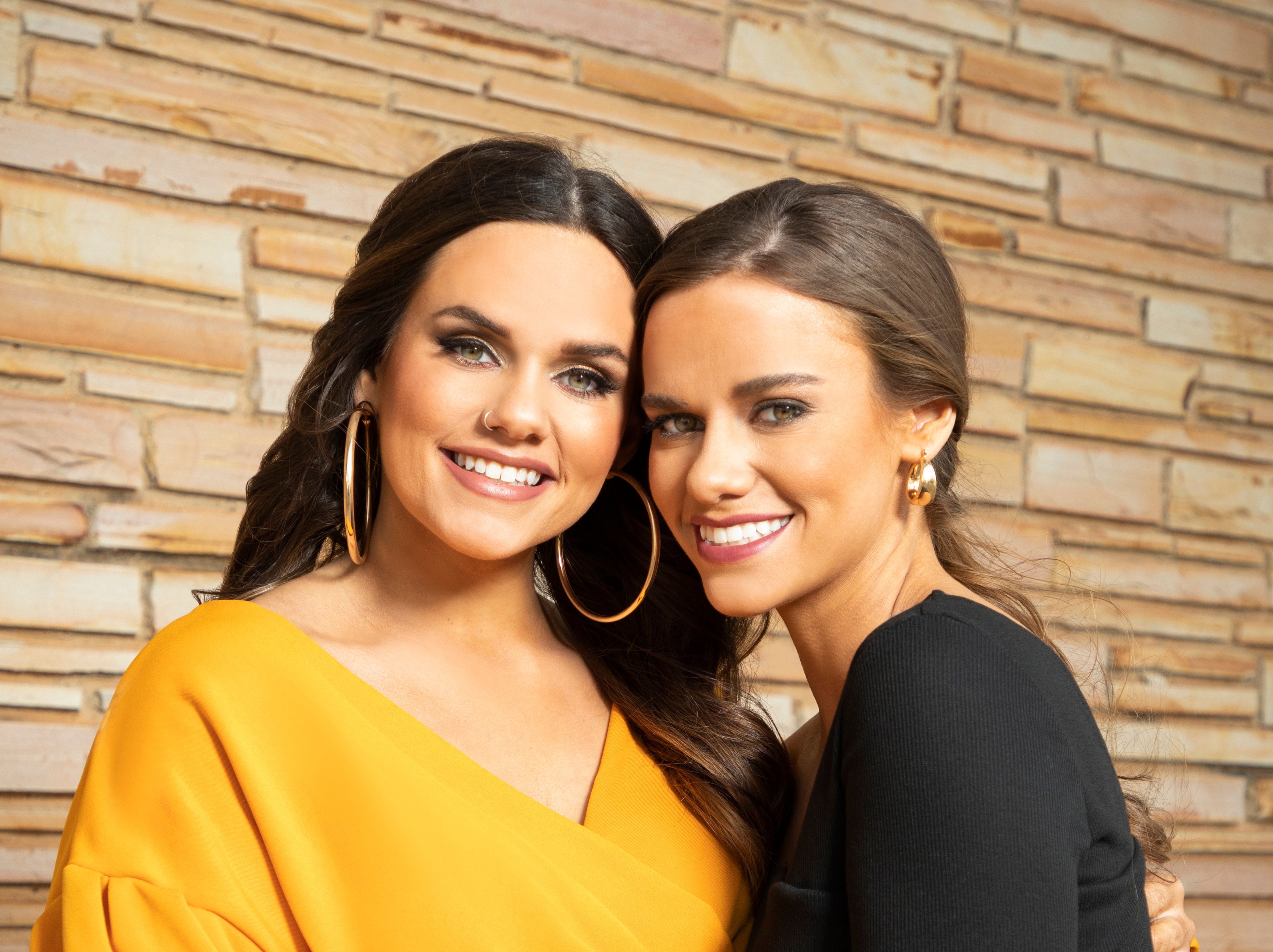 Brooke and Baylee from Extreme Sisters in front of brick wall