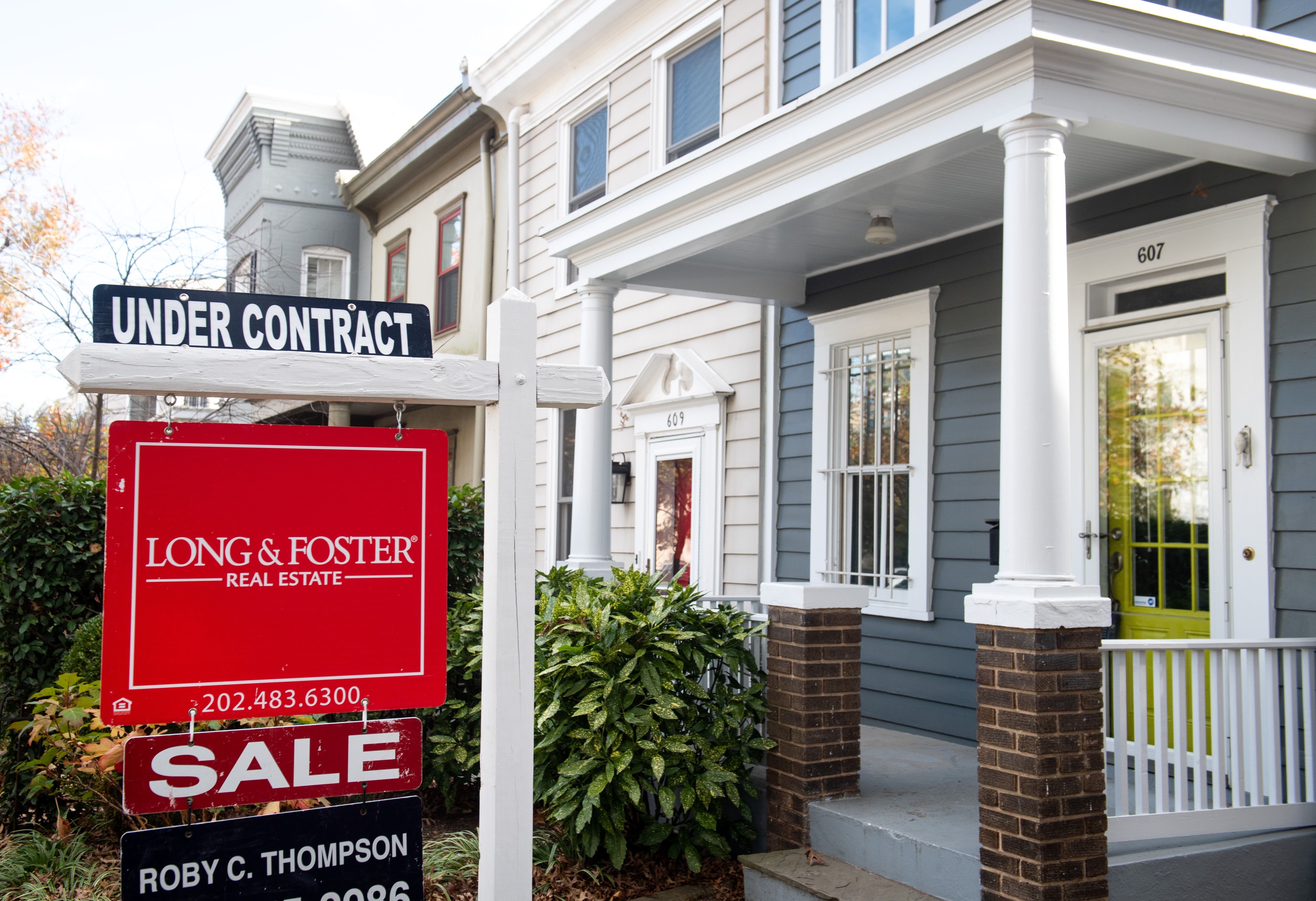 A for sale under contract sign outside of a row home in Washington DC