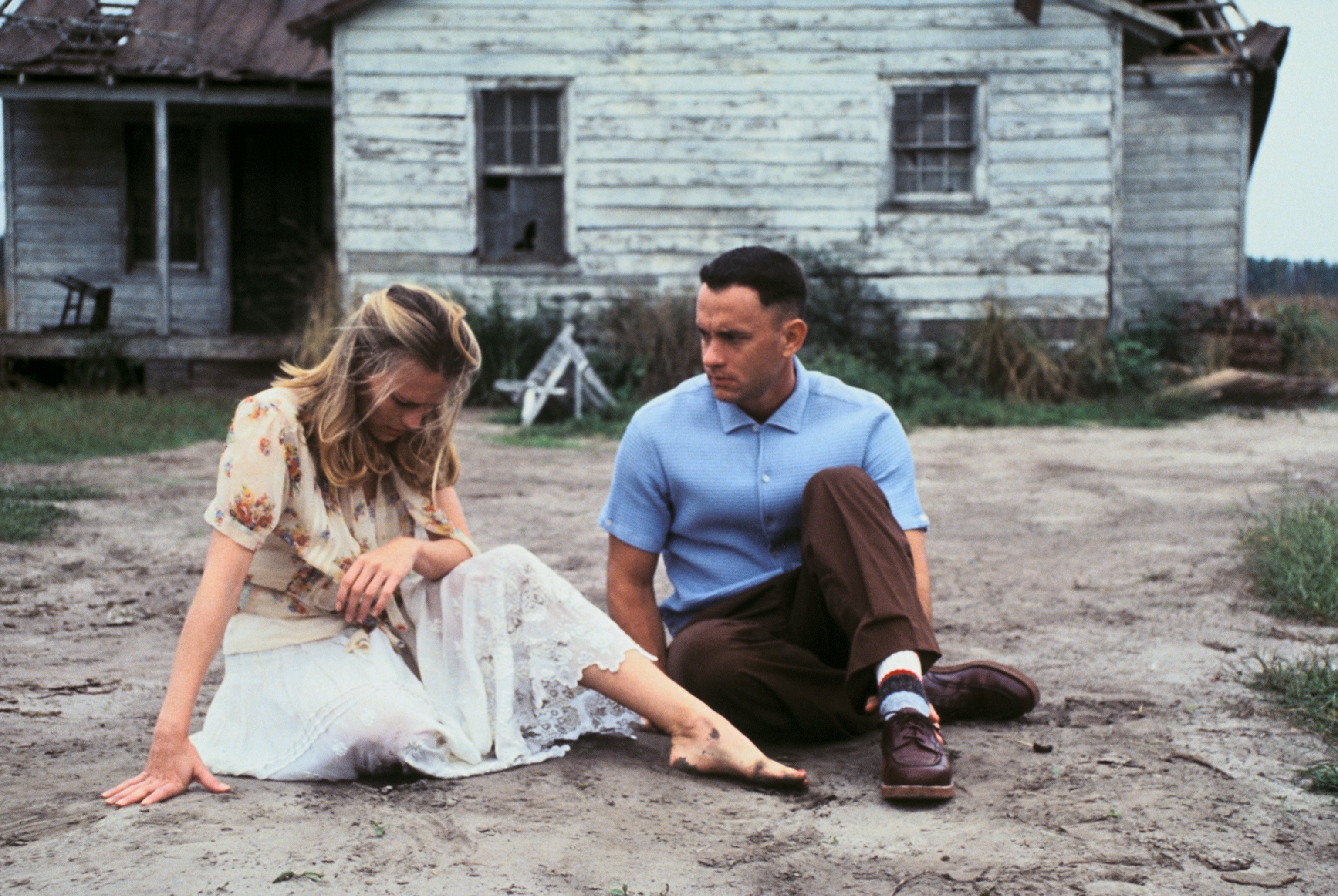 Jenny and Forrest Gump sit in the dirt