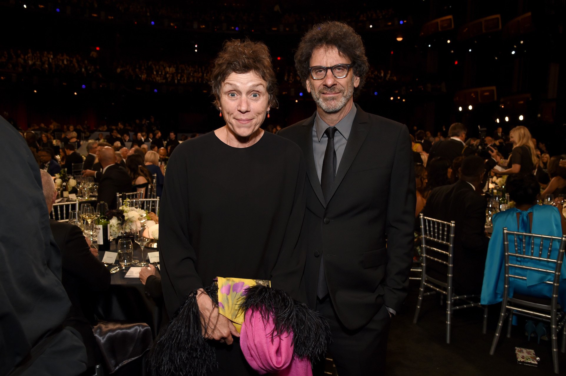 (L-R) Frances McDormand and husband Joel Coen standing together and looking at the camera