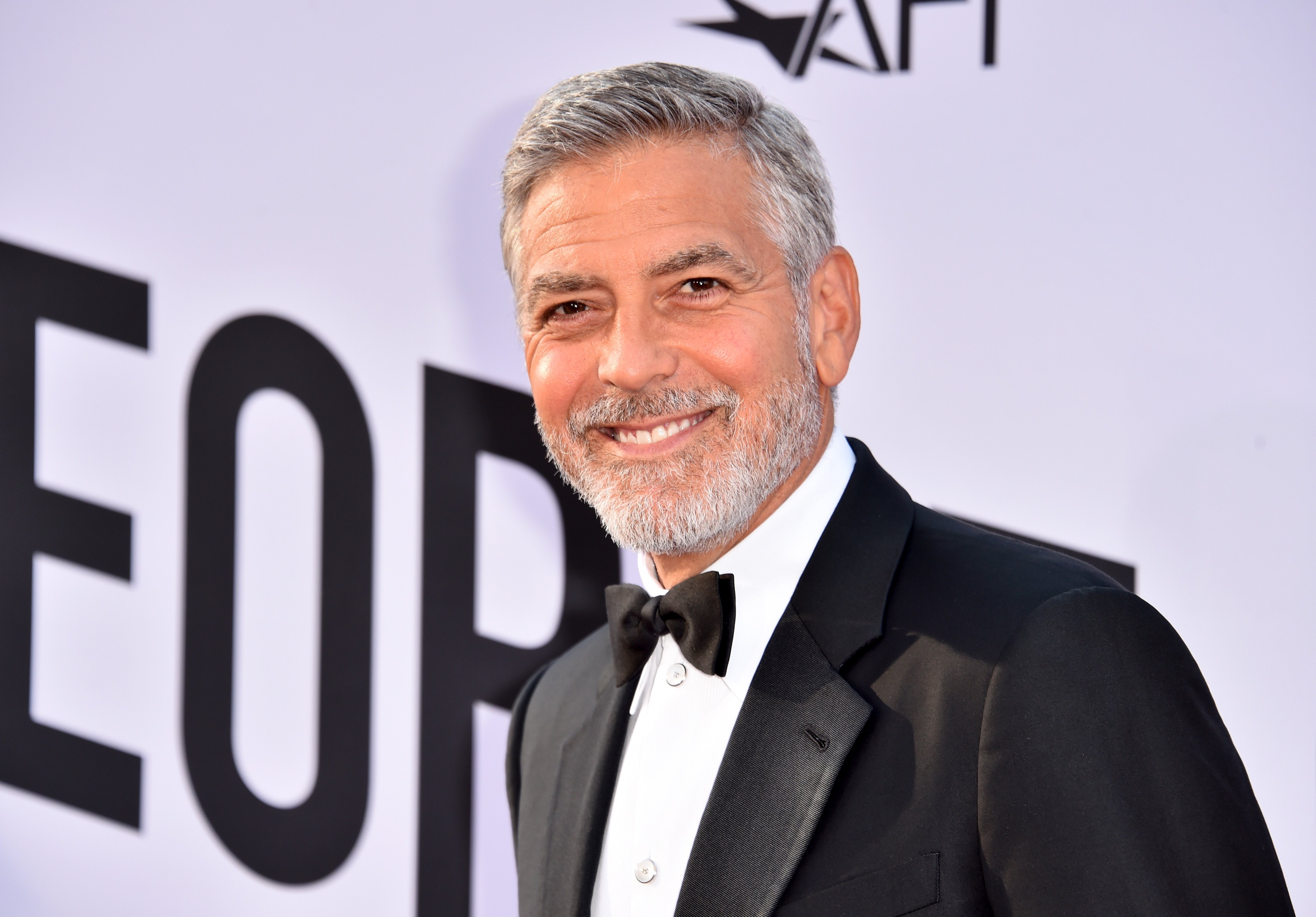 George Clooney smiling in a tuxedo at the American Film Institute's 46th Life Achievement Award Gala Tribute