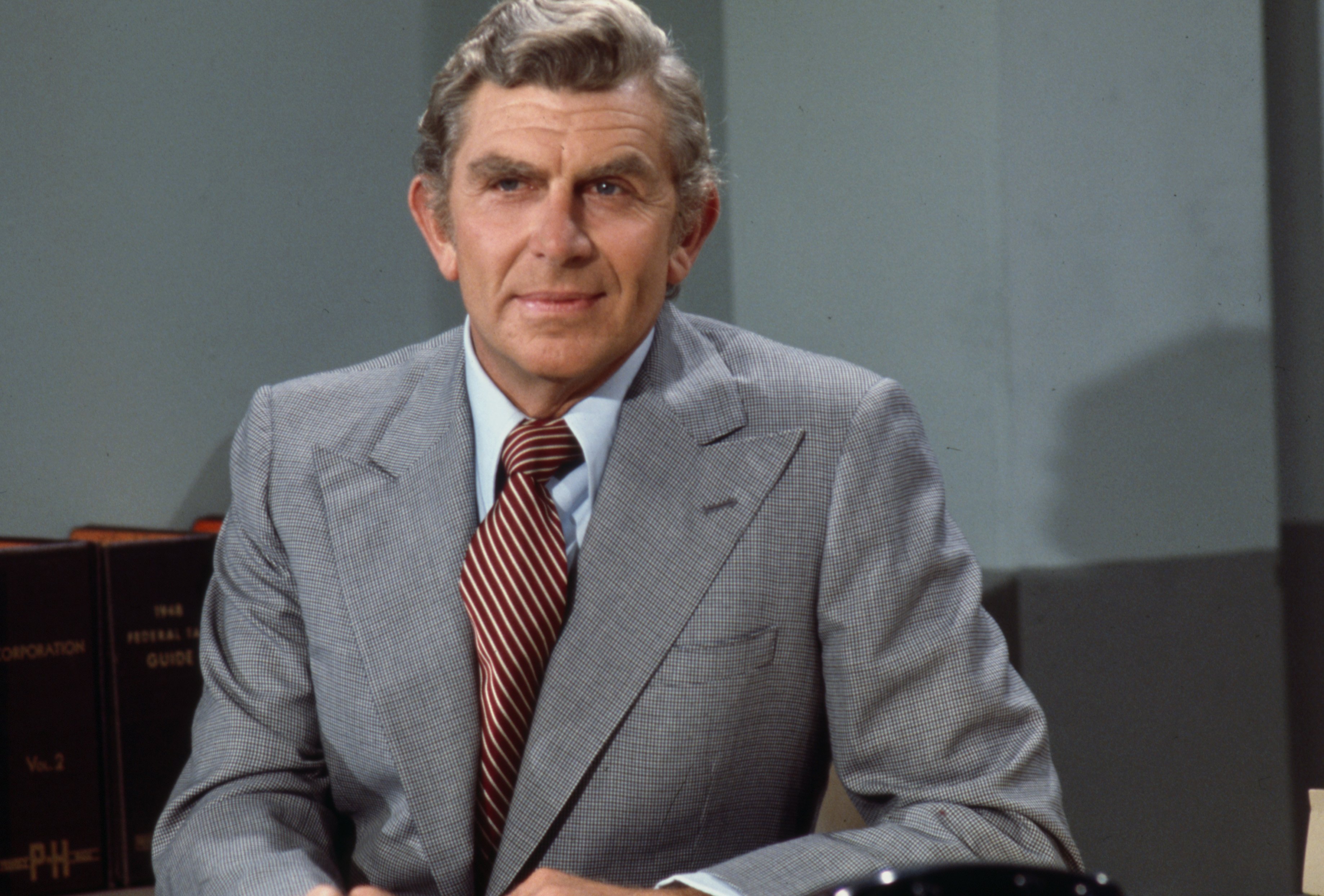 Portrait of Andy Griffith in a gray suit and yellow tie in 1976