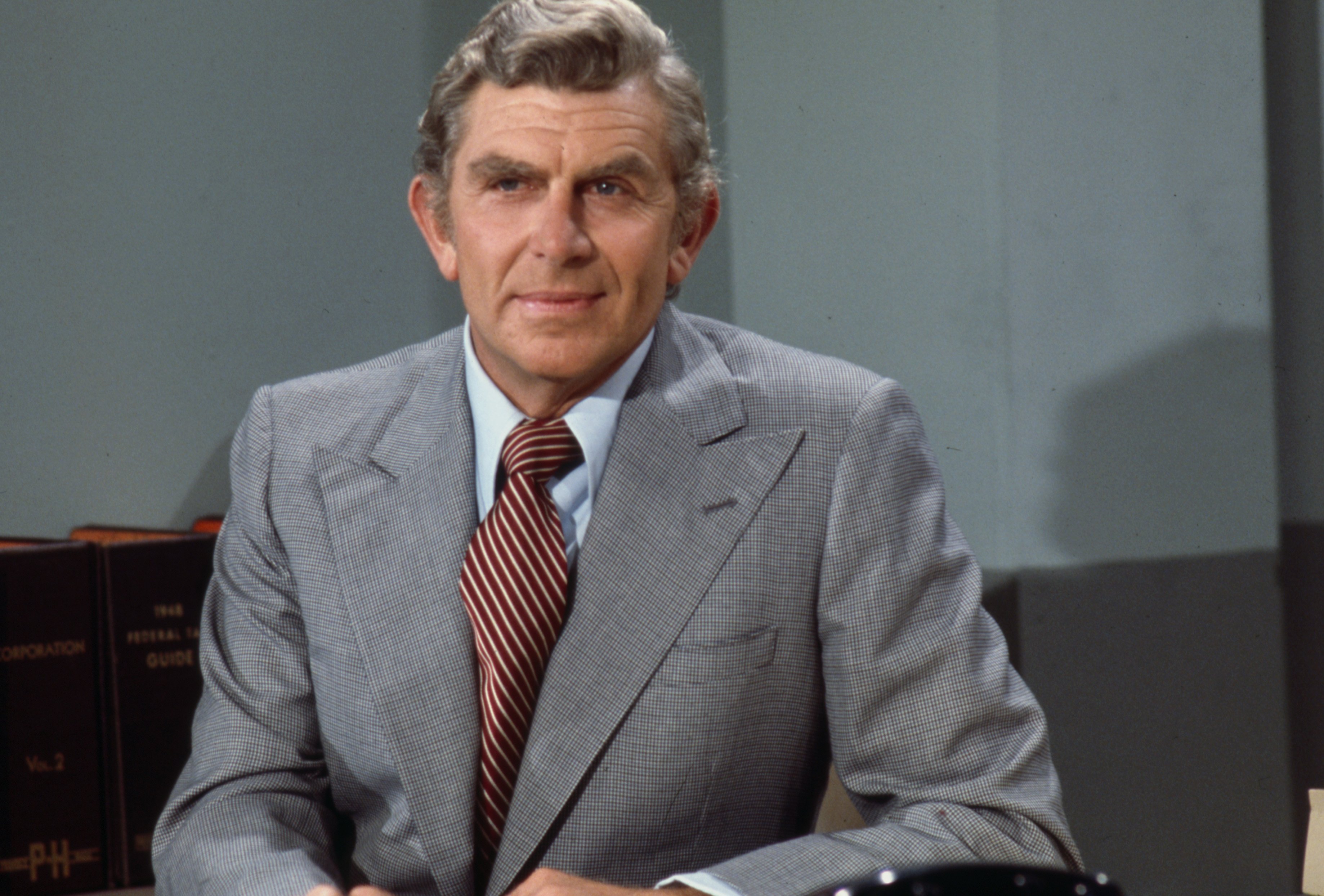 Portrait of Andy Griffith in a gray suit and yellow tie in 1976